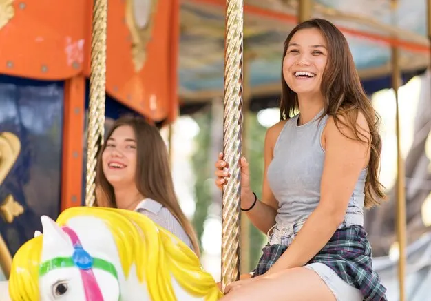 Smiley female friends having fun carousel