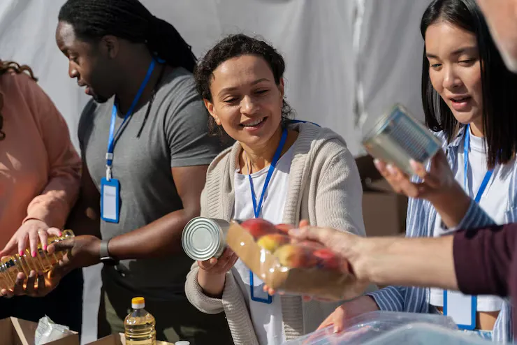 Volunteers sorting tinned goods into relief packs