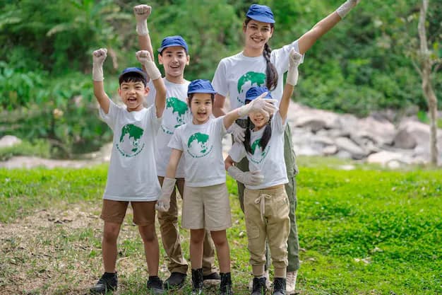 Volunteers and children with their arms raised together